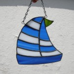 Stained glass sailboat with multi stripe sail. $35 plus shipping.