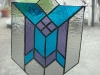 geometric stained glass in blue, purple, and clear